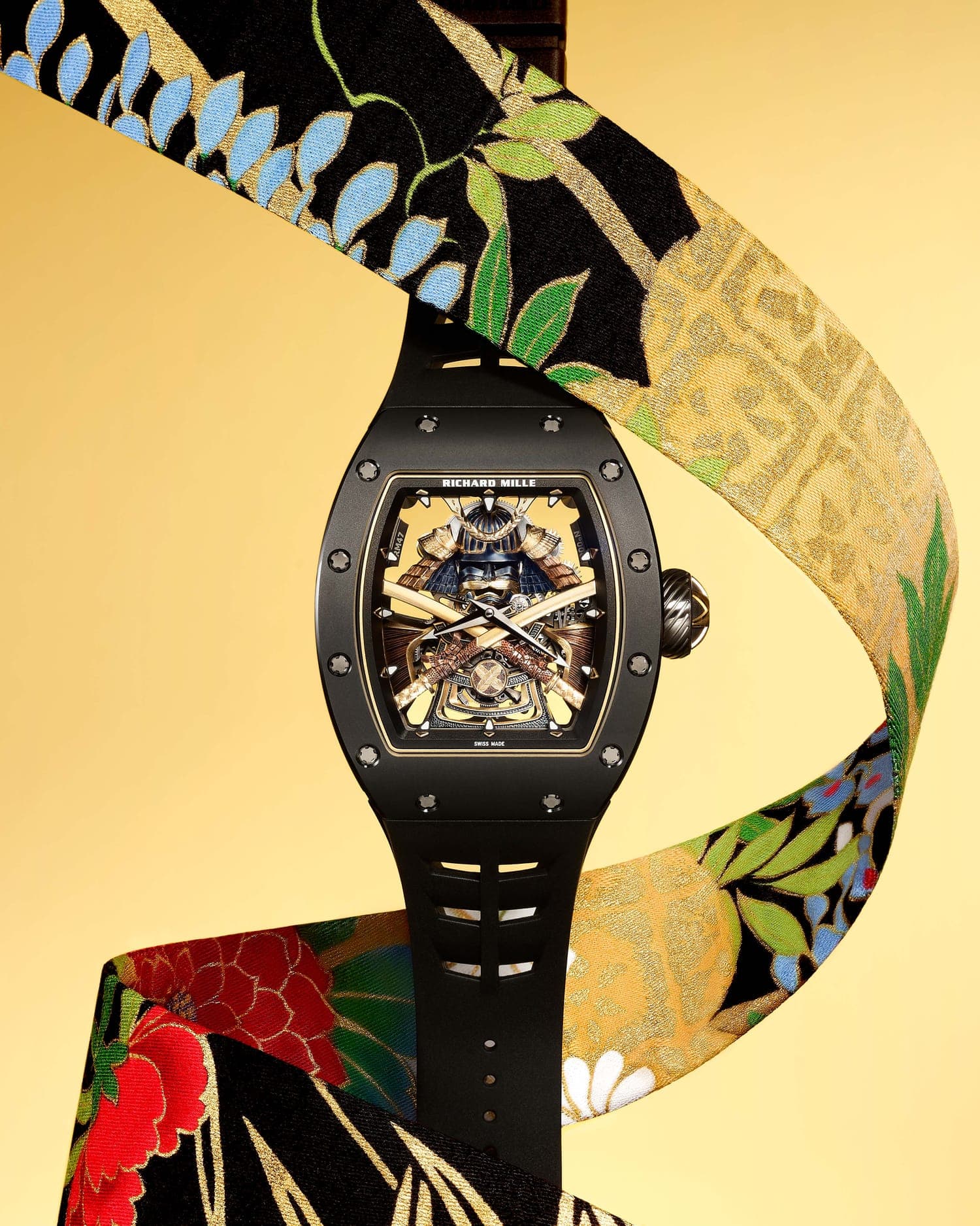 A luxury tourbillon watch displayed on ornate gold fabric