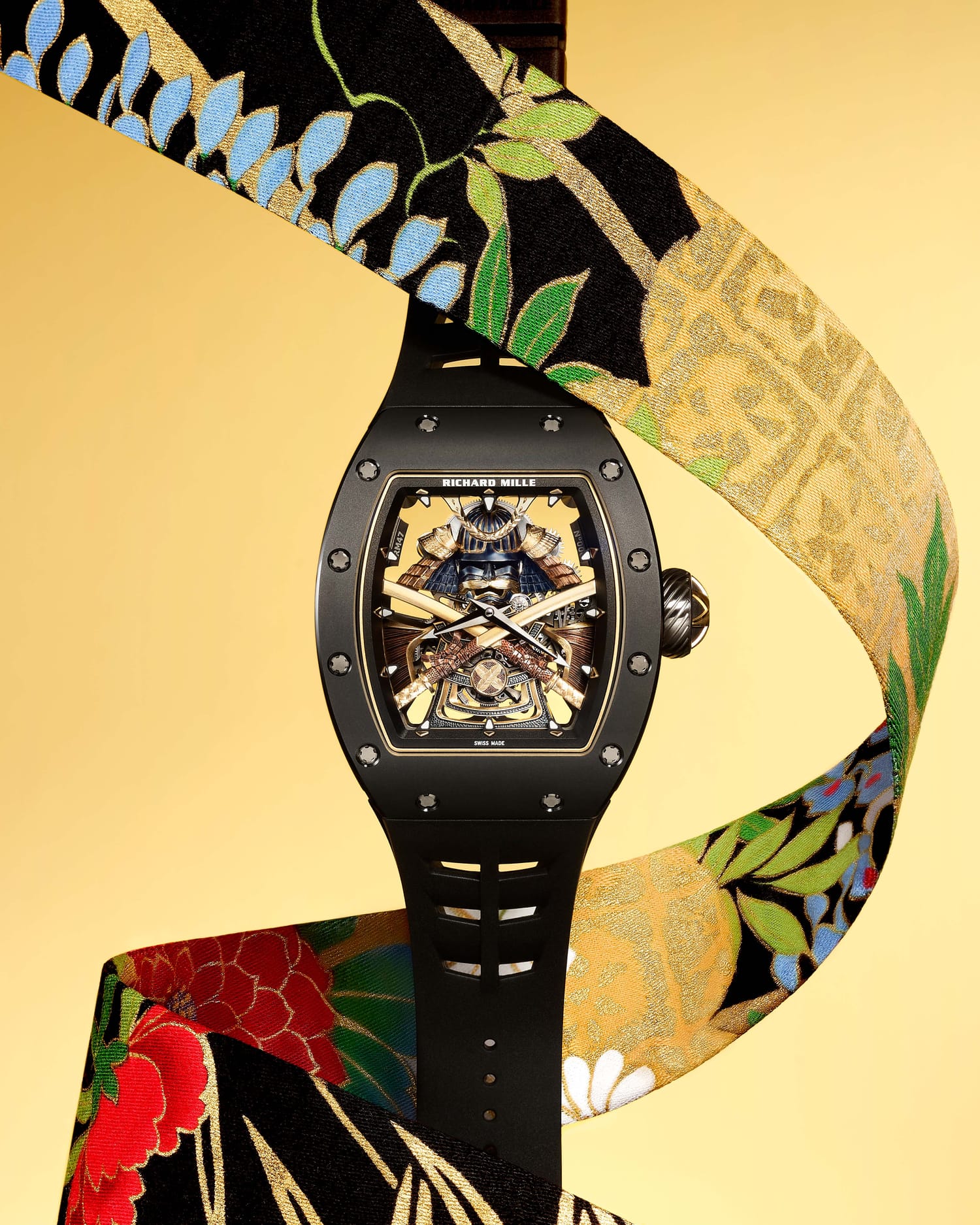 A luxury tourbillon watch displayed on ornate gold fabric